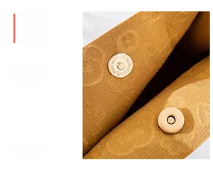 Detail of camel embossed faux leather bag featuring secure dual golden magnetic closures