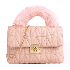 Pink quilted PU leather handbag with faux fur handle and gold chain strap on white background