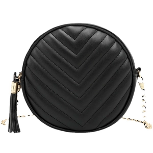Quilted round black chain bag with elegant gold zipper and stylish leather tassel charm
