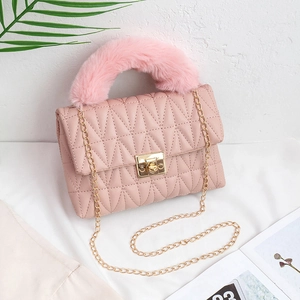 Pink quilted crossbody bag with plush faux fur handle and gold chain shoulder strap