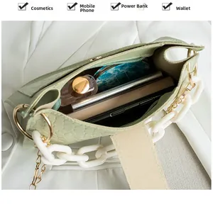 Detail view of large capacity interior for light green crocodile pattern handbag with chain