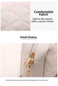 Macro shot of white quilted faux leather texture and polished golden zipper hardware