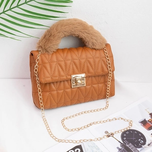 Brown quilted crossbody bag with faux fur handle and gold chain strap in a 45-degree view