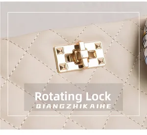 Detailed close-up of golden twist-lock on beige quilted leather large chain handbag