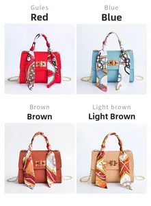Detail of four candy-colored handbags with silk scarves and golden chain straps
