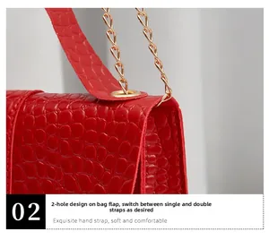 Detail of red crocodile pattern handbag with gold chain and dual-hole lid design