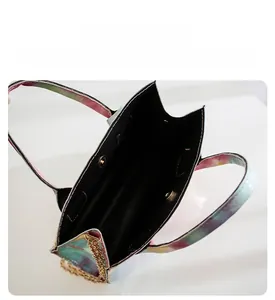 Top view of gradient leather handbag with gold chain strap and magnetic snap closure