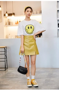 Outfit estivo con gonna gialla, t-shirt smile e borsa a tracolla con trama coccodrillo