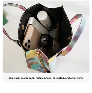Detail view of large capacity interior with magnetic buckle and golden chain for mini bag