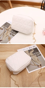 Detailed close-up of white quilted PU leather crossbody bag with elegant gold chain strap