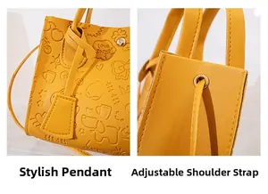 Detail of ginger yellow handbag showing embossed cartoon patterns and metal magnetic clasp