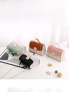 Detailed display of plaid patchwork handbags in green, brown, pink, and black with gold chains