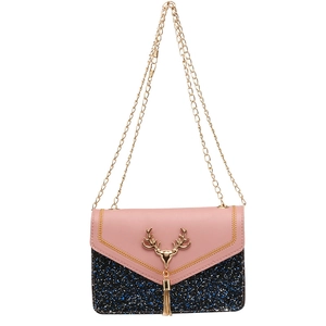 Pink and blue sequin crossbody bag featuring a golden deer head and chain tassel