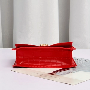 Elegant red crocodile textured square handbag with pearl chain and gold clasp detail