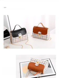 Close-up of the stylish plaid fabric and lizard-textured leather flap with metal lock