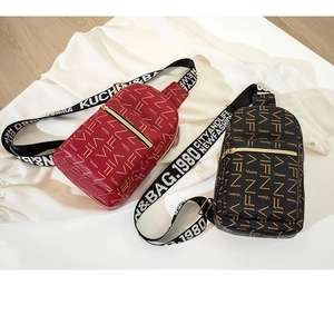 Detail of lychee textured leather crossbody bags with VIFN logo and wide fabric straps