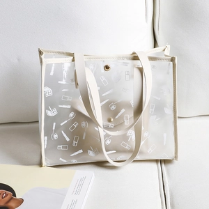 Chic PVC tote bag with white cosmetic prints and cream top handles on a soft white sofa