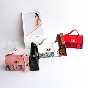 Ladies snakeskin patterned handbags in pink black white brown and red with chain straps