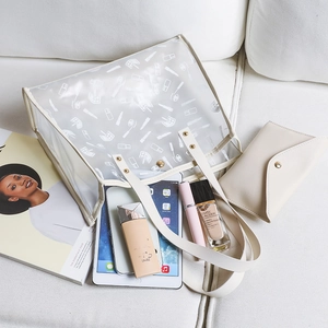 Transparent PVC tote bag with white cosmetic print and matching beige mini pouch
