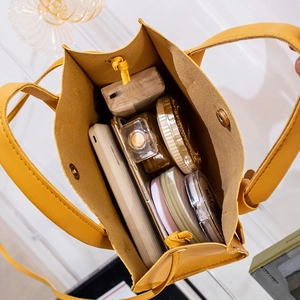 Minimalist yellow leather tote bag with a spacious interior for daily essentials