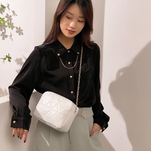 White quilted crossbody square bag with geometric patterns and golden chain strap