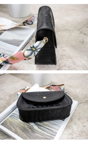 Dettaglio borsa a sella nera coccodrillo con manico decorato da un elegante foulard in seta