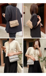Detail of quilted chain shoulder bags in apricot and gray with golden twist locks