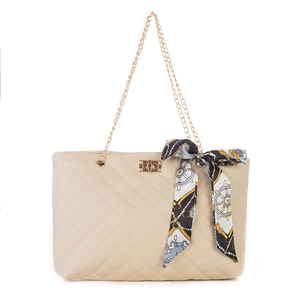 Quilted beige handbag with gold chain strap and floral silk scarf on handle