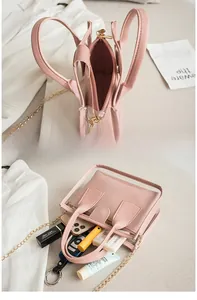 Detailed view of pink transparent crossbody bag showing interior storage for daily makeup items