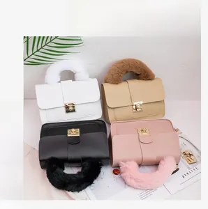 Detail of four small square bags in white, beige, black, and pink with plush faux fur handles
