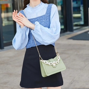 Pale green crocodile embossed hobo bag with gold chain and white acrylic strap