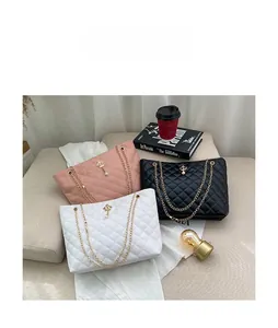 Quilted chain bucket bags in pink, white, and black with crown charms and pearls