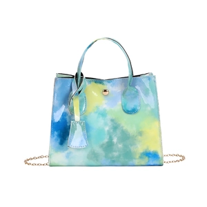 Chic women's tote bag in blue and yellow watercolor patent leather with gold chain strap