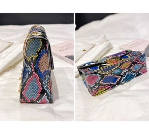 Detail of multi-color snakeskin textured crossbody bag with golden chain and clasp