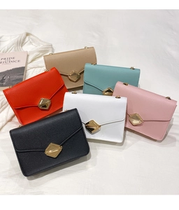 Collection of mini chain bags in six colors with gold diamond buckles on white fabric