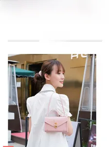 Detail of pink croc-embossed mini bag with elegant gold metal and pearl twist lock