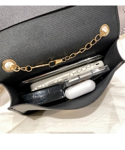 Top view of mini cross-body bag interior showing space for phone and accessories