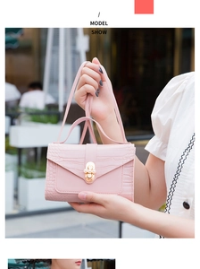 Pink crocodile pattern mini bag featuring a stylish golden pearl clasp and slim strap