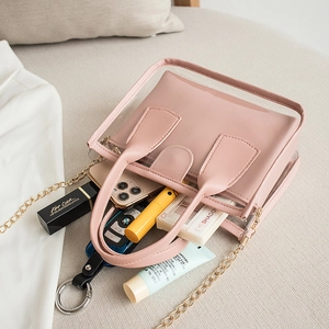 Pink transparent PVC tote bag with inner pouch, chain strap, and crossbody handle