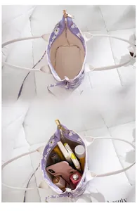 Internal storage of a purple daisy floral mini bucket bag with daily essentials
