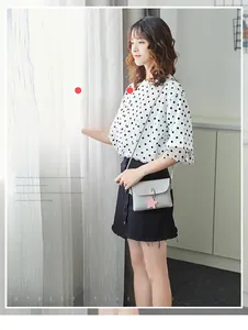 Mini grey crossbody square bag with gold buckle and cute pink star charm on model