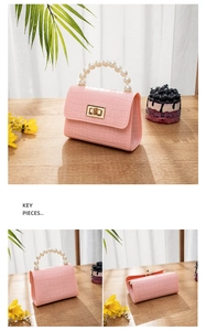 Detail of pink croc-embossed mini jelly bag with pearl handle and gold twist lock