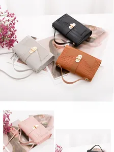 Detailed close-up of crocodile pattern mini bags with elegant pearl clasp and shoulder strap