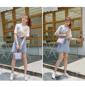 Close-up of lavender daisy print canvas crossbody bag with coordinated casual street outfit
