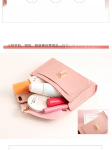 Detail of pink crocodile pattern mini bag interior with pearl clasp and large capacity