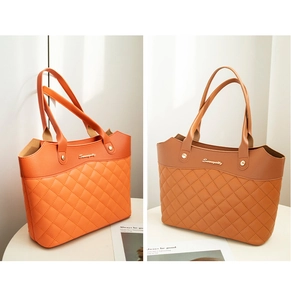 Detail of diamond quilted stitching and brand lettering on orange and camel tote bags