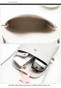 Detail view of grey crossbody bag showing internal capacity and star pendant accessory