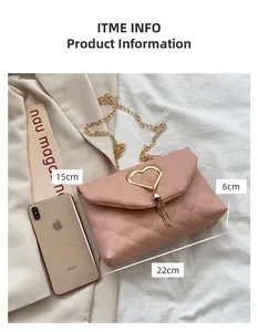 Detail of pink quilted crossbody bag with heart buckle and gold chain strap