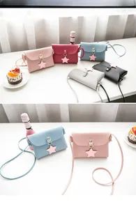 Detail of mini crossbody bags with star charms and snap closure in various colors