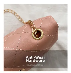 Close-up of pink quilted leather bag with golden chain and anti-wear hardware